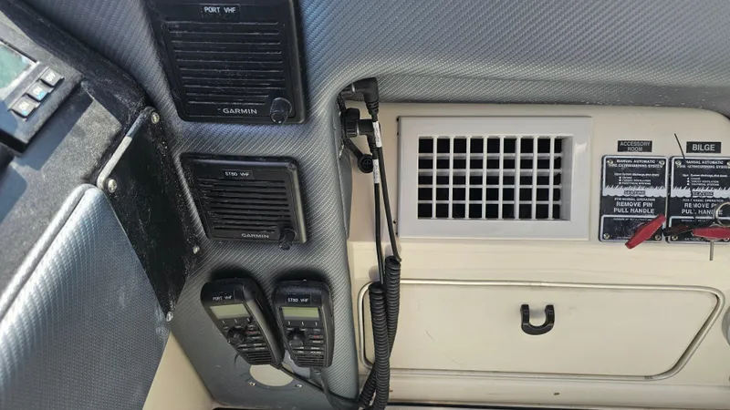 Slide: The Image of Control panel of a 1999 Sea Ray 500 Sundancer boat with communication devices. - 21