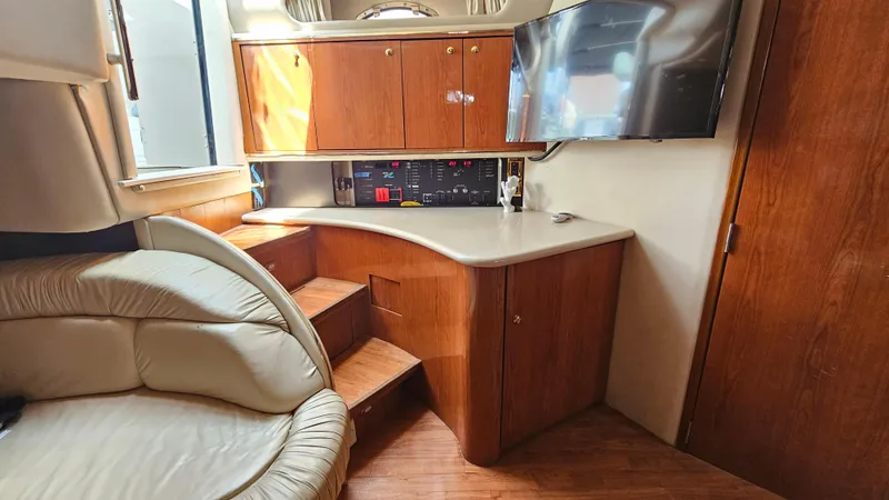 Slide: The Image of Interior of 1999 Sea Ray 500 Sundancer yacht with wood cabinetry and leather seating. - 27