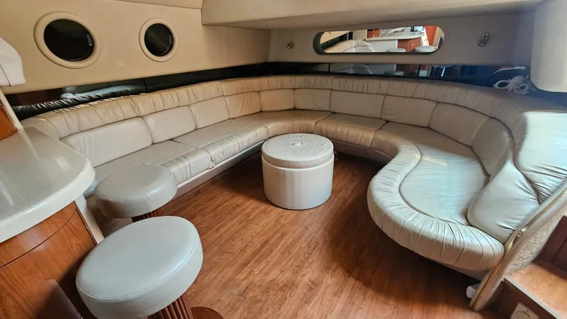 Slide: The Image of Luxurious interior of 1999 Sea Ray 500 Sundancer with curved leather seating and wooden flooring. - 41