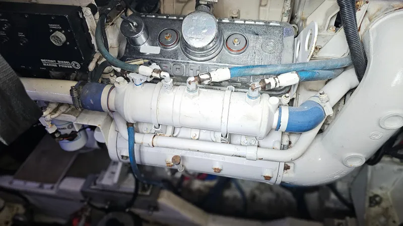 Slide: The Image of Engine component of a 1999 Sea Ray 500 Sundancer boat, featuring pipes and connectors. - 44