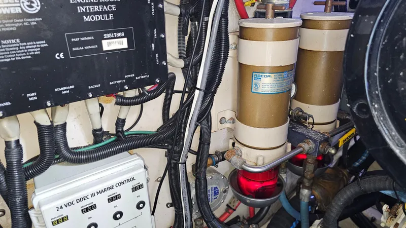 Slide: The Image of Engine room of a 1999 Sea Ray 500 Sundancer with wiring and fuel filters. - 46