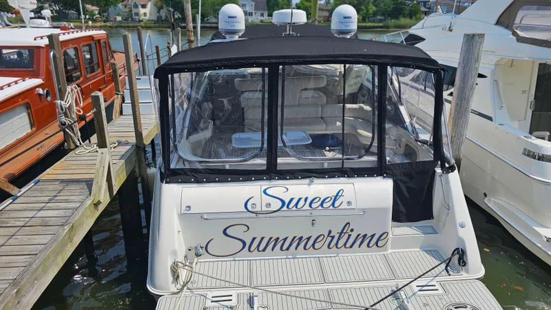 Slide: The Image of 1999 Sea Ray 500 Sundancer docked, named "Sweet Summertime," with covered seating area. - 48