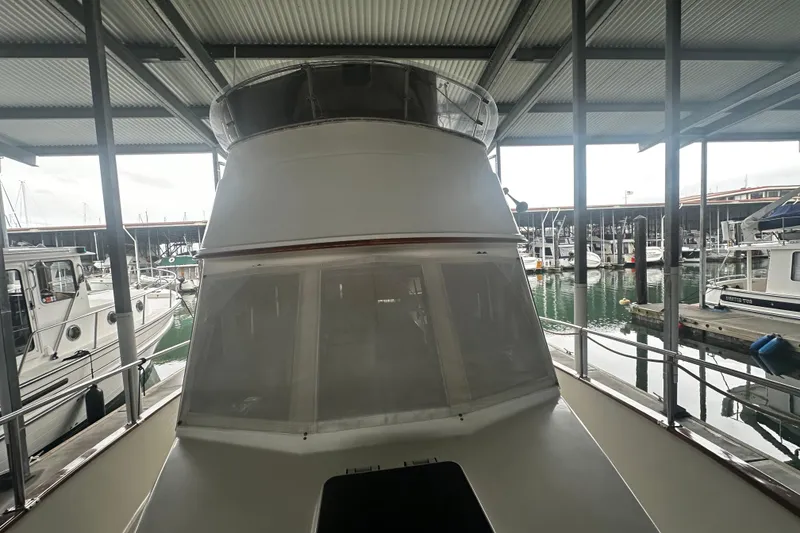Slide: The Image of Island Gypsy 36 yacht from 2000 docked in a marina under a covered shelter. - 4