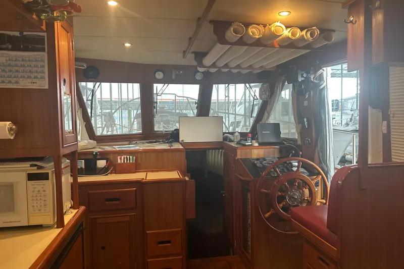 Slide: The Image of Interior of 2000 Island Gypsy 36 boat with wooden helm and navigation equipment. - 6