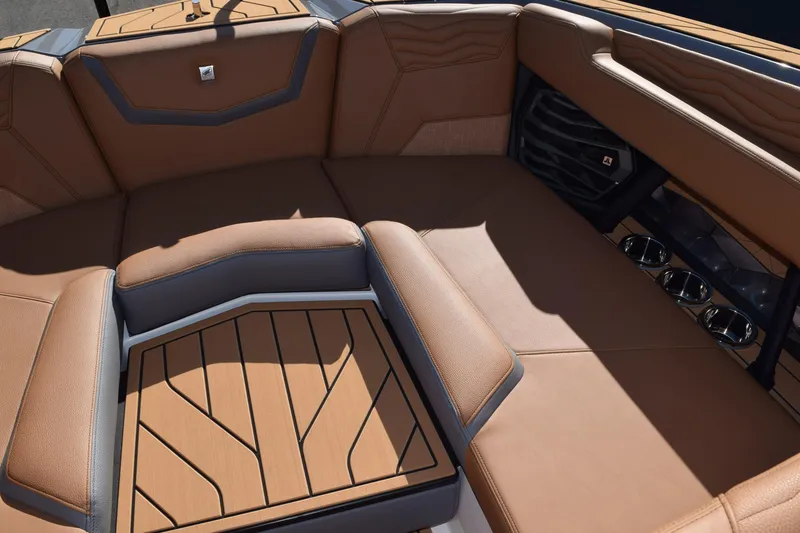 Slide: The Image of 2025 Nautique Super Air Nautique G23 Paragon interior with luxurious tan seating and cup holders. - 11