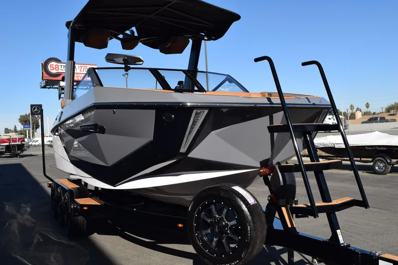The Image of 2025 Nautique Super Air Nautique G23 Paragon boat on trailer, sleek design, outdoor display. - 0