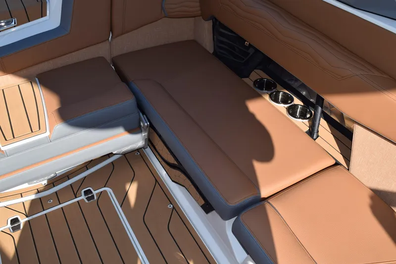 Slide: The Image of 2025 Nautique Super Air Nautique G23 Paragon interior with tan seating and cup holders. - 13