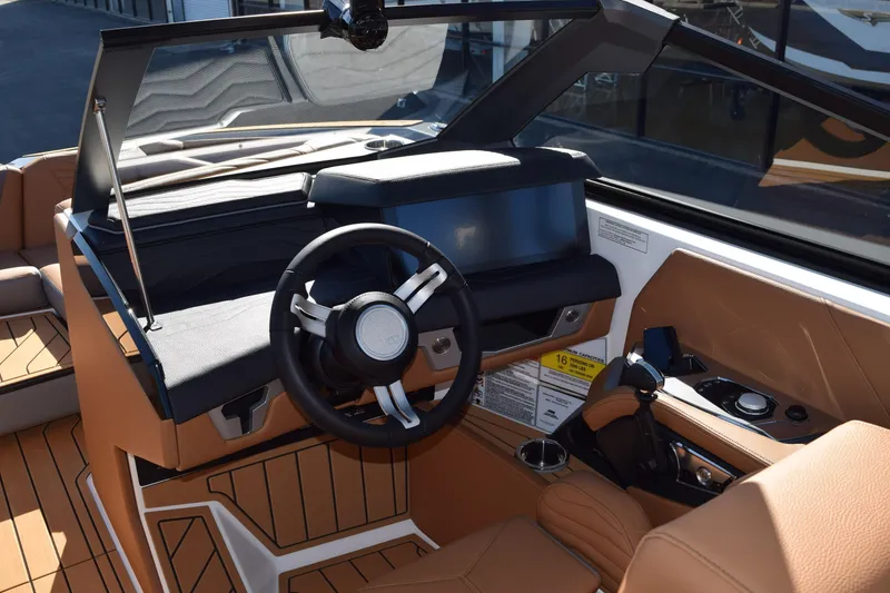 Slide: The Image of 2025 Nautique Super Air Nautique G23 Paragon cockpit with modern steering and controls. - 3