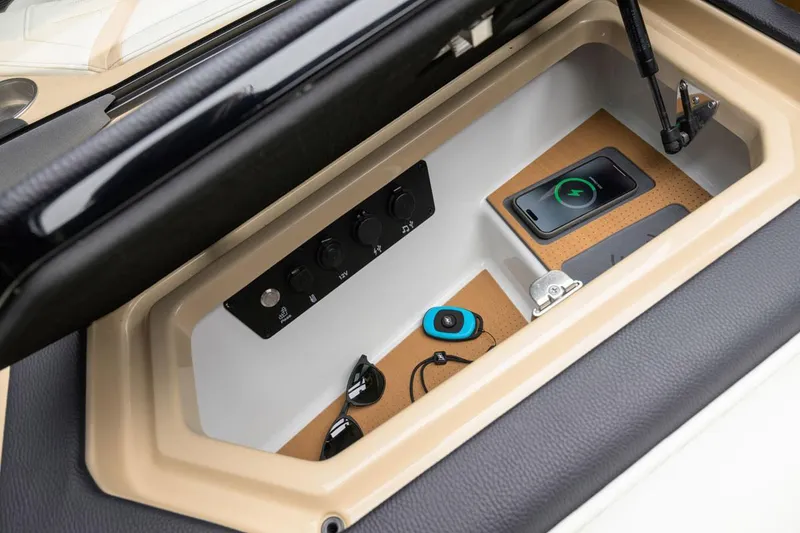 Slide: The Image of Manufacturer Provided Image: Storage compartment in 2025 Nautique Super Air Nautique G23 Paragon with wireless charging pad. - 32