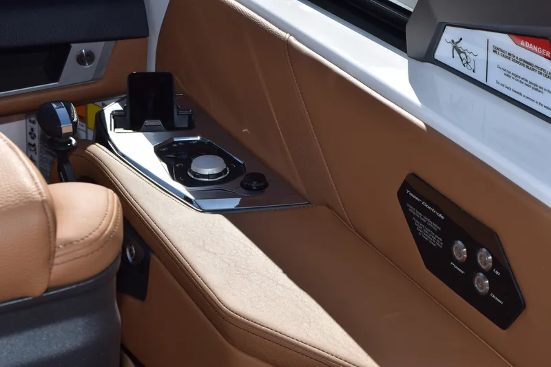 Slide: The Image of Interior of 2025 Nautique Super Air Nautique G23 Paragon with tan leather and control panel. - 4