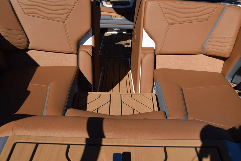 Slide: The Image of Luxurious interior of 2025 Nautique Super Air Nautique G23 Paragon with tan leather seating. - 9