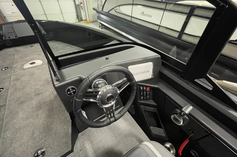 Slide: The Image of 2026 Alumacraft Competitor 175X Sport boat cockpit with steering wheel and Garmin display. - 10