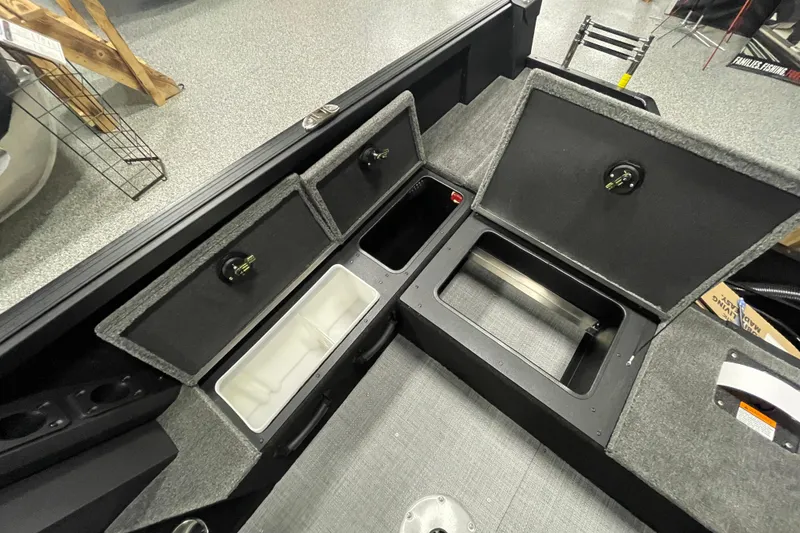 Slide: The Image of 2026 Alumacraft Competitor 175X Sport boat storage compartments with open lids, showcasing interior space. - 12