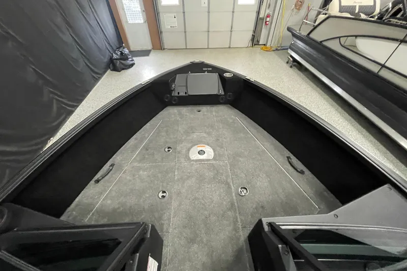 Slide: The Image of 2026 Alumacraft Competitor 175X Sport boat interior with spacious deck in a garage setting. - 6