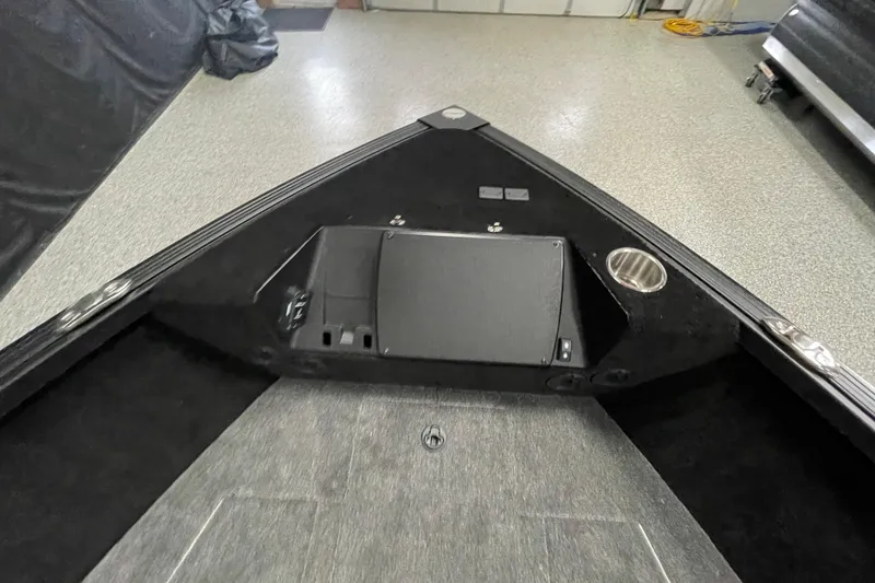 Slide: The Image of 2026 Alumacraft Competitor 175X Sport boat interior with storage compartment and cup holder. - 7