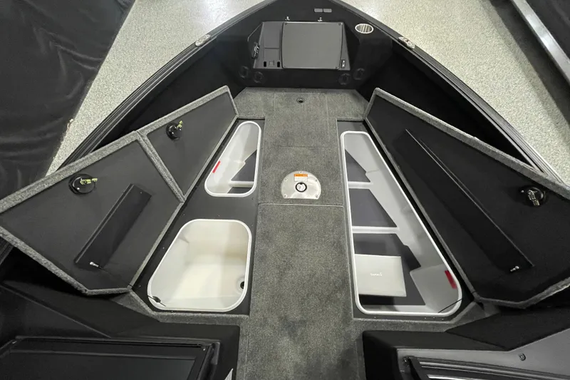 Slide: The Image of 2026 Alumacraft Competitor 175X Sport boat interior with open storage compartments. - 8