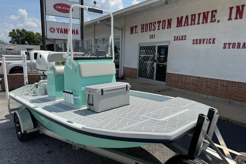 Slide: The Image of 2025 Mowdy 16 Cat boat on trailer outside Mt. Houston Marine dealership. - 1