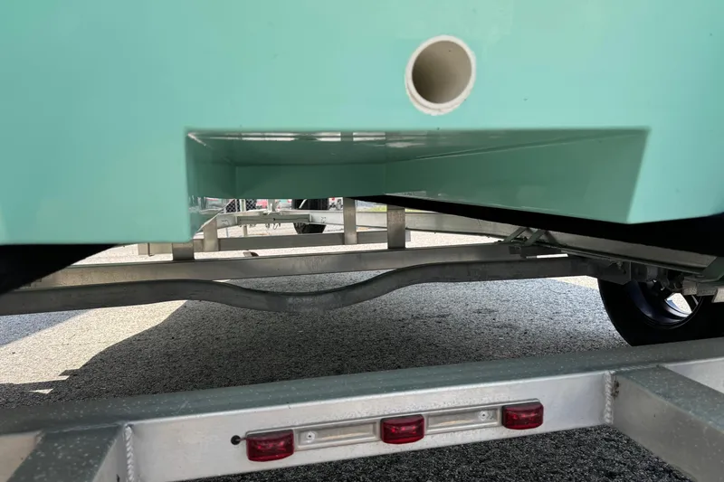 Slide: The Image of 2025 Mowdy 16 Cat boat on trailer, showcasing hull and trailer details. - 10