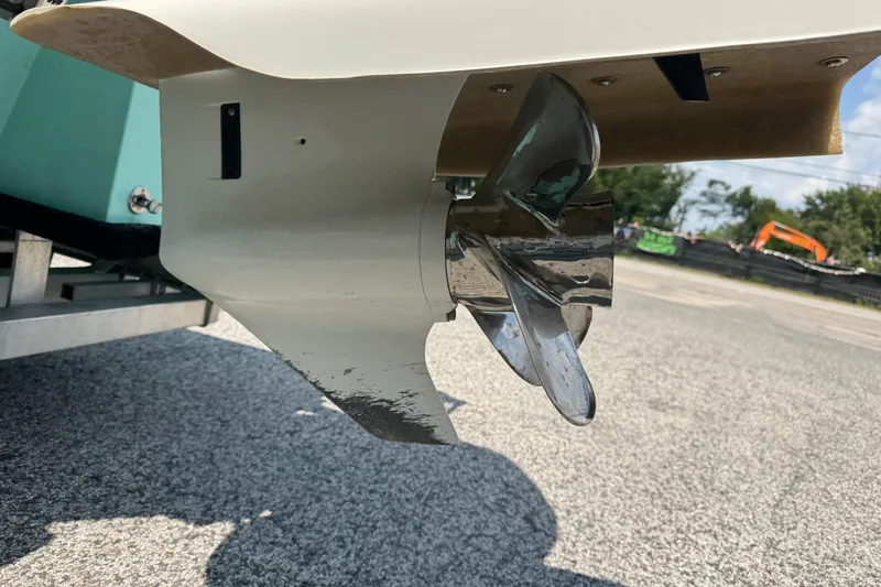 Slide: The Image of Propeller of 2025 Mowdy 16 Cat boat on a trailer, close-up view. - 12