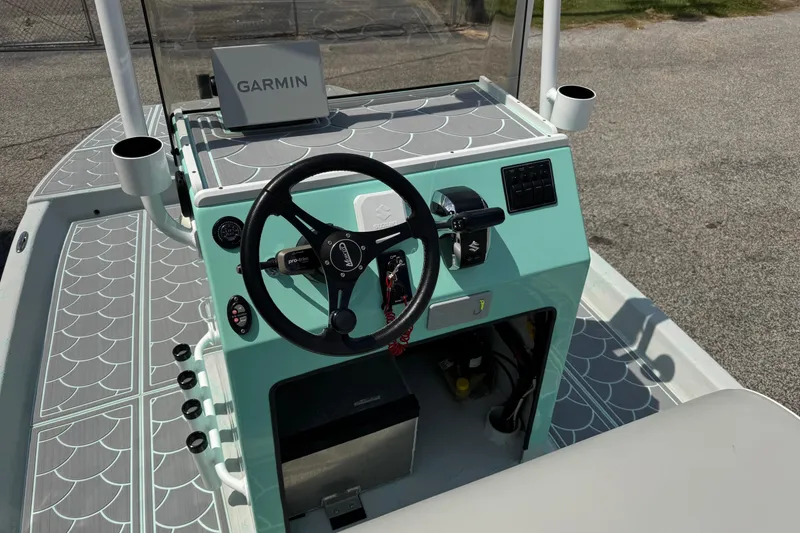 Slide: The Image of 2025 Mowdy 16 Cat boat console with Garmin navigation system and stylish design. - 6