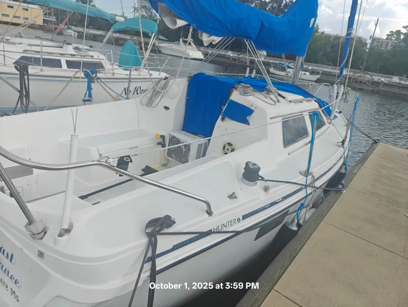 The Image of Hunter 27-2 sailboat docked, featuring blue sail covers, photographed on October 1, 2025. - 0