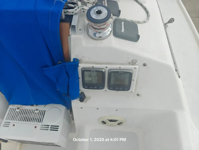 Slide: The Image of Control panel of a 1990 Hunter 27-2 sailboat with navigation instruments and blue cover. - 11