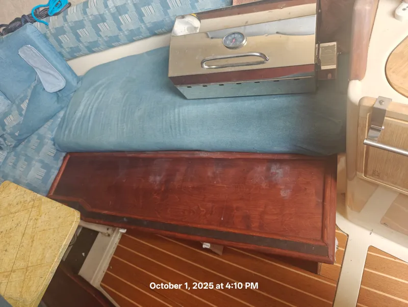 Slide: The Image of Interior of a 1990 Hunter 27-2 sailboat with seating and wooden cabinetry. - 20
