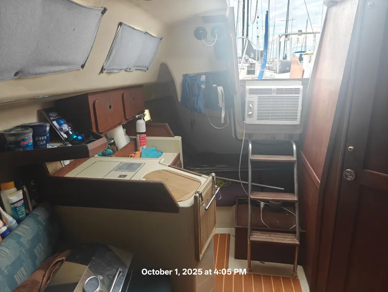Slide: The Image of Interior of a 1990 Hunter 27-2 sailboat with wooden cabinetry and air conditioning unit. - 24