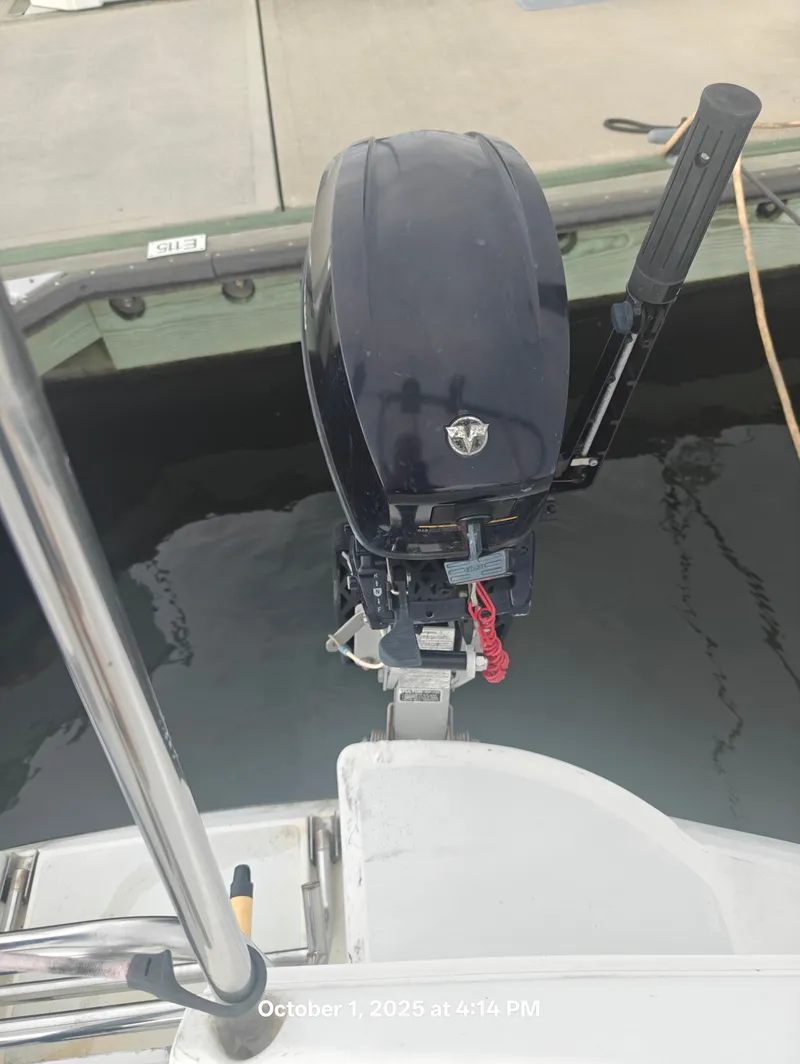 Slide: The Image of Outboard motor on a 1990 Hunter 27-2 sailboat docked at a marina. - 38