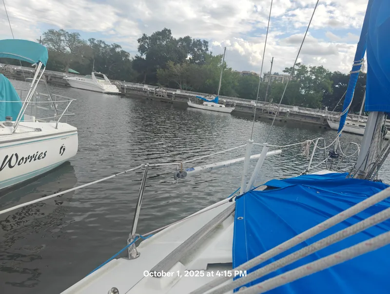 Slide: The Image of Sailboats docked at a marina, featuring a 1990 Hunter 27-2 under cloudy skies. - 39
