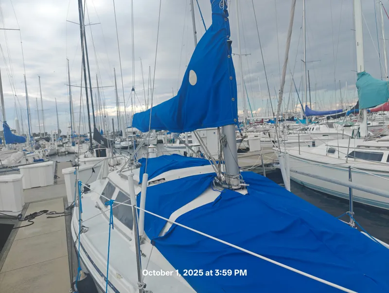 Slide: The Image of Sailboat Hunter 27-2, 1990 model, docked at marina with blue covers. - 5