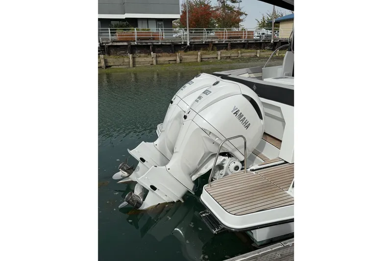 Slide: The Image of 2025 Jeanneau NC 1095 Fly with twin Yamaha outboard engines docked. - 21