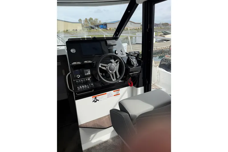 Slide: The Image of 2025 Jeanneau NC 1095 Fly helm with modern controls and navigation system. - 24
