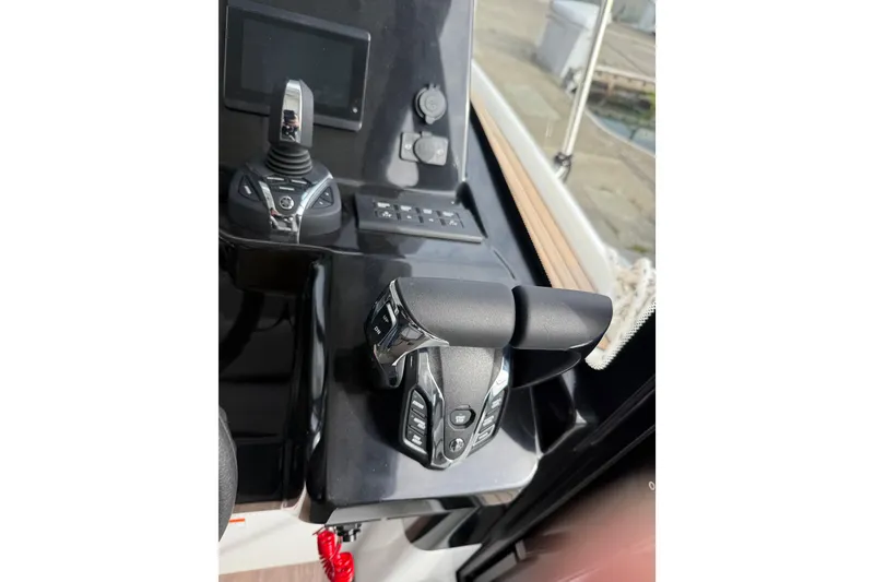 Slide: The Image of 2025 Jeanneau NC 1095 Fly helm controls with joystick and throttle levers. - 25