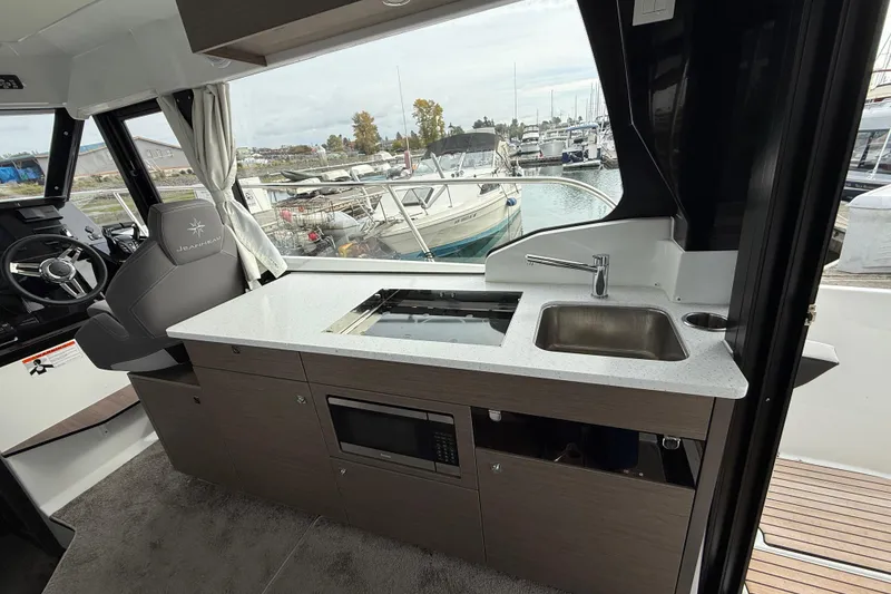 Slide: The Image of 2025 Jeanneau NC 1095 Fly interior with modern kitchen and steering area. - 28