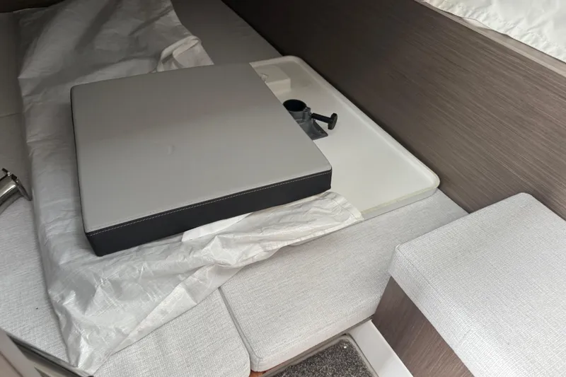 Slide: The Image of Interior seating area of 2025 Jeanneau NC 1095 Fly boat with cushion and table. - 30