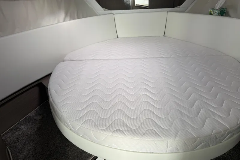 Slide: The Image of 2025 Jeanneau NC 1095 Fly cabin with round bed and white upholstery. - 31