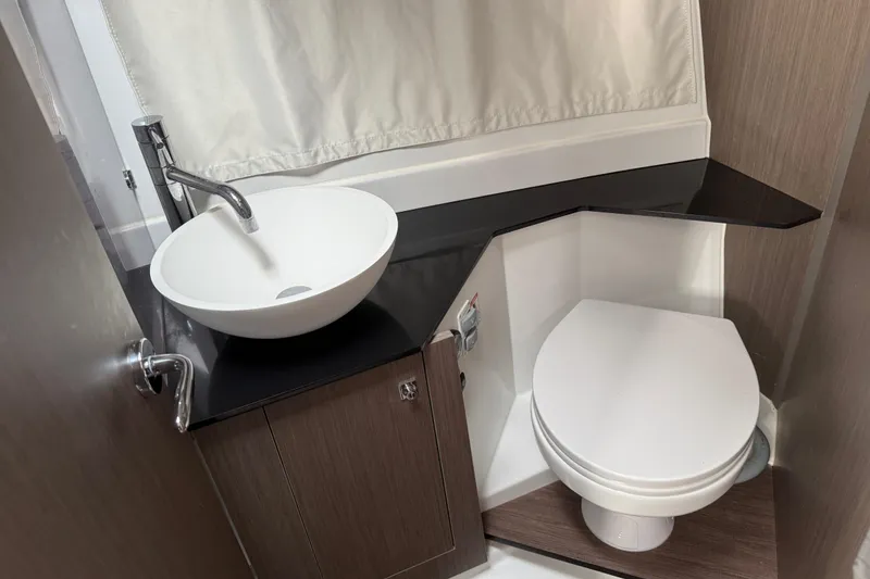 Slide: The Image of 2025 Jeanneau NC 1095 Fly bathroom with modern sink and toilet. - 32