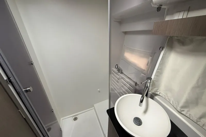 Slide: The Image of Modern bathroom in 2025 Jeanneau NC 1095 Fly yacht, featuring sleek sink and shower. - 33