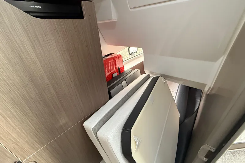 Slide: The Image of Interior of 2025 Jeanneau NC 1095 Fly, featuring modern cabinetry and seating. - 34