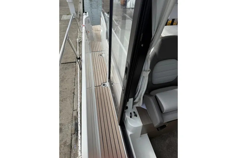 Slide: The Image of 2025 Jeanneau NC 1095 Fly boat deck with seating and railing. - 38