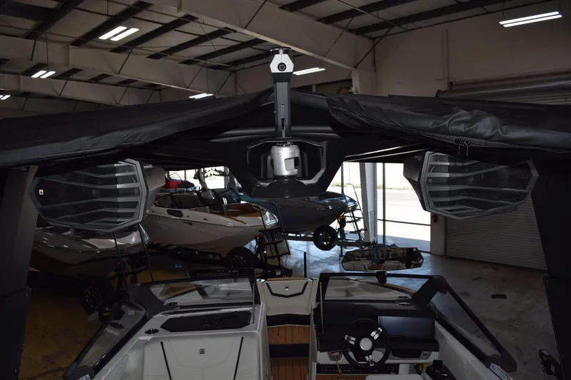 Slide: The Image of 2025 Nautique Super Air Nautique G23 interior with advanced sound system in showroom. - 12