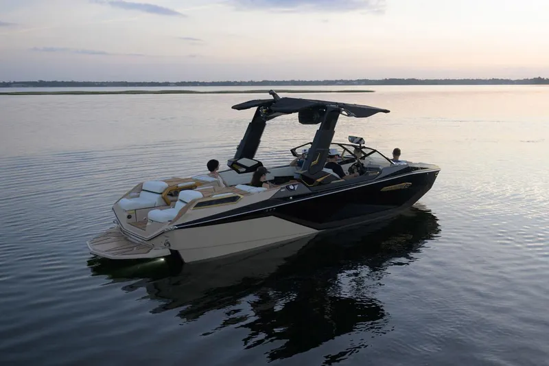 Slide: The Image of Manufacturer Provided Image: 2025 Nautique Super Air Nautique G23 Paragon boat on calm water at sunset. - 20