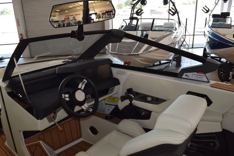 Slide: The Image of 2025 Nautique Super Air Nautique G23 interior with modern dashboard and steering wheel. - 4