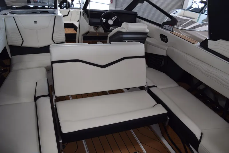 Slide: The Image of 2025 Nautique Super Air Nautique G23 interior with white seating and modern design. - 8