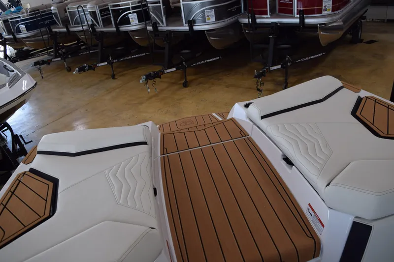 Slide: The Image of 2025 Nautique Super Air Nautique G23 boat interior with sleek seating and wood accents. - 9