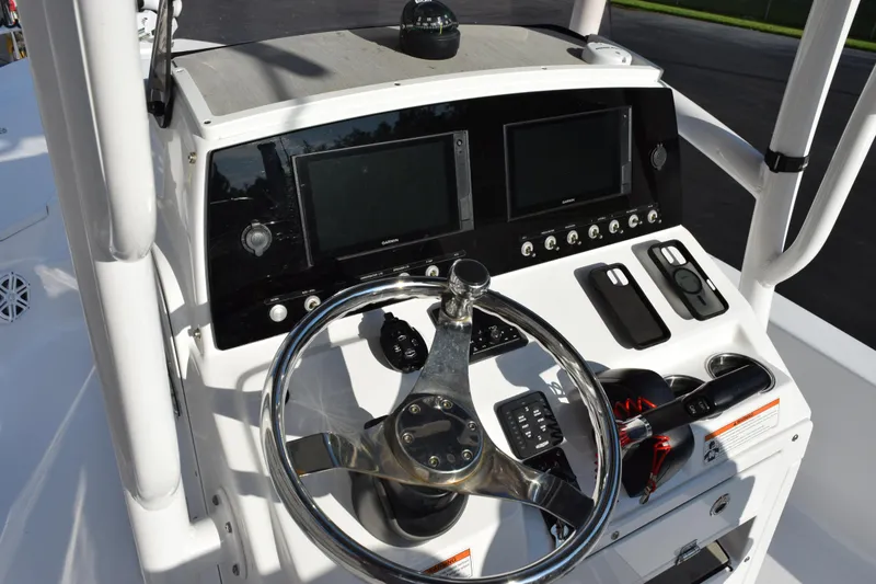 Slide: The Image of 2021 Sportsman Tournament 234 Bay Boat dashboard with steering wheel and electronic displays. - 10