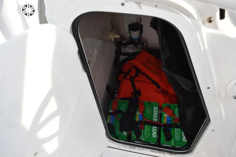 Slide: The Image of Storage compartment in 2021 Sportsman Tournament 234 Bay Boat with life jackets and batteries. - 21