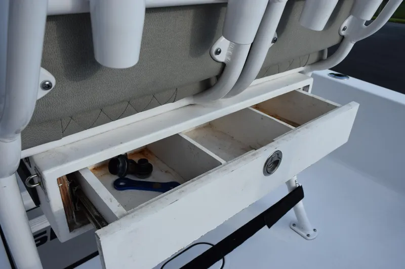 Slide: The Image of Open storage compartment on 2021 Sportsman Tournament 234 Bay Boat with fishing gear. - 22