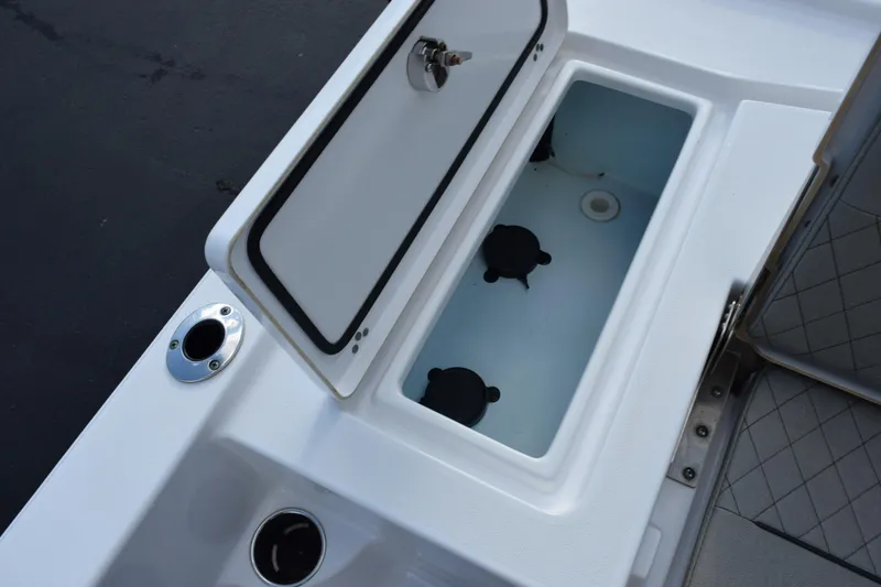 Slide: The Image of 2021 Sportsman Tournament 234 Bay Boat livewell with open lid and seating detail. - 24